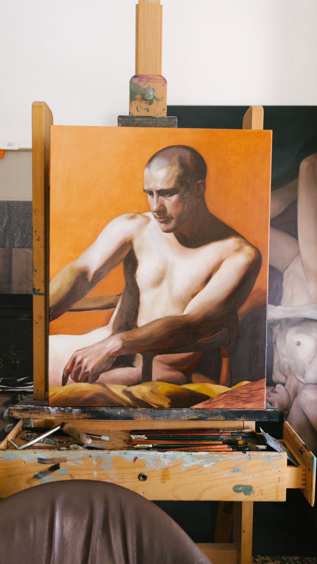 A portrait in oils on an orange ground resting on Anthony's easel