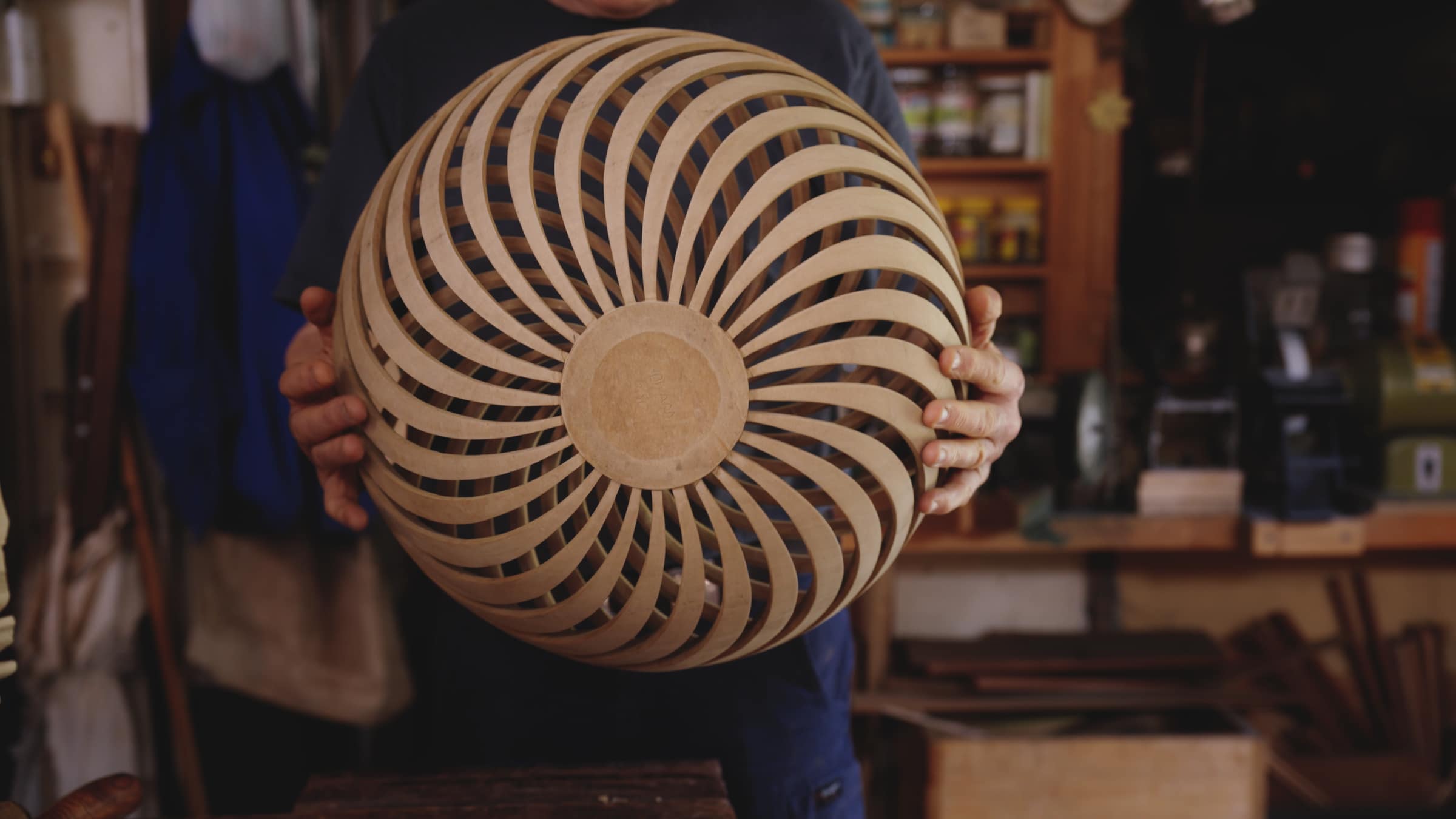 Robert holding up a carved bowl with spiralling slots