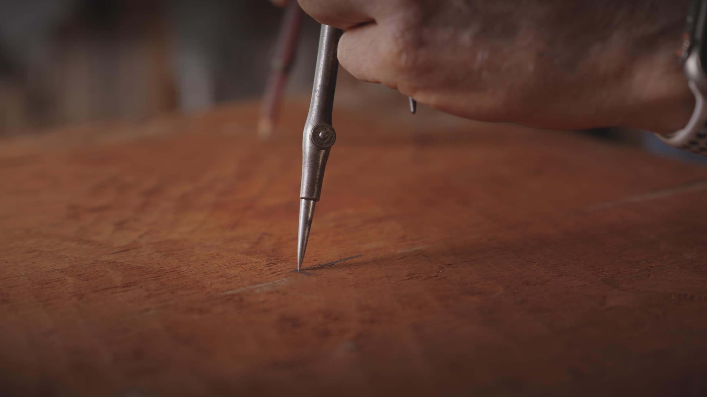 Robert marking out a block of timber with a scribe