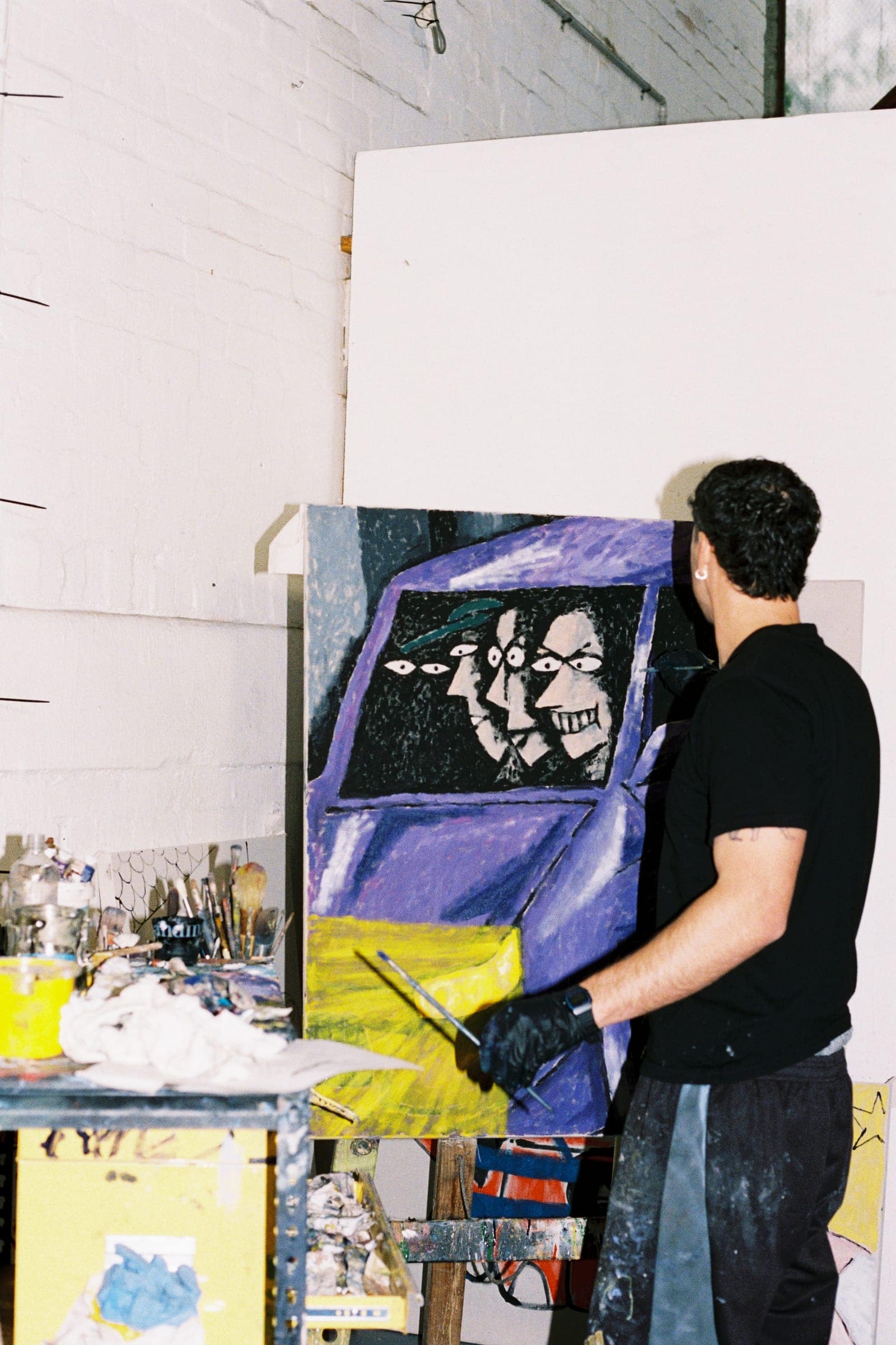 Chris working on the new enamel painting at the easel, shot on film