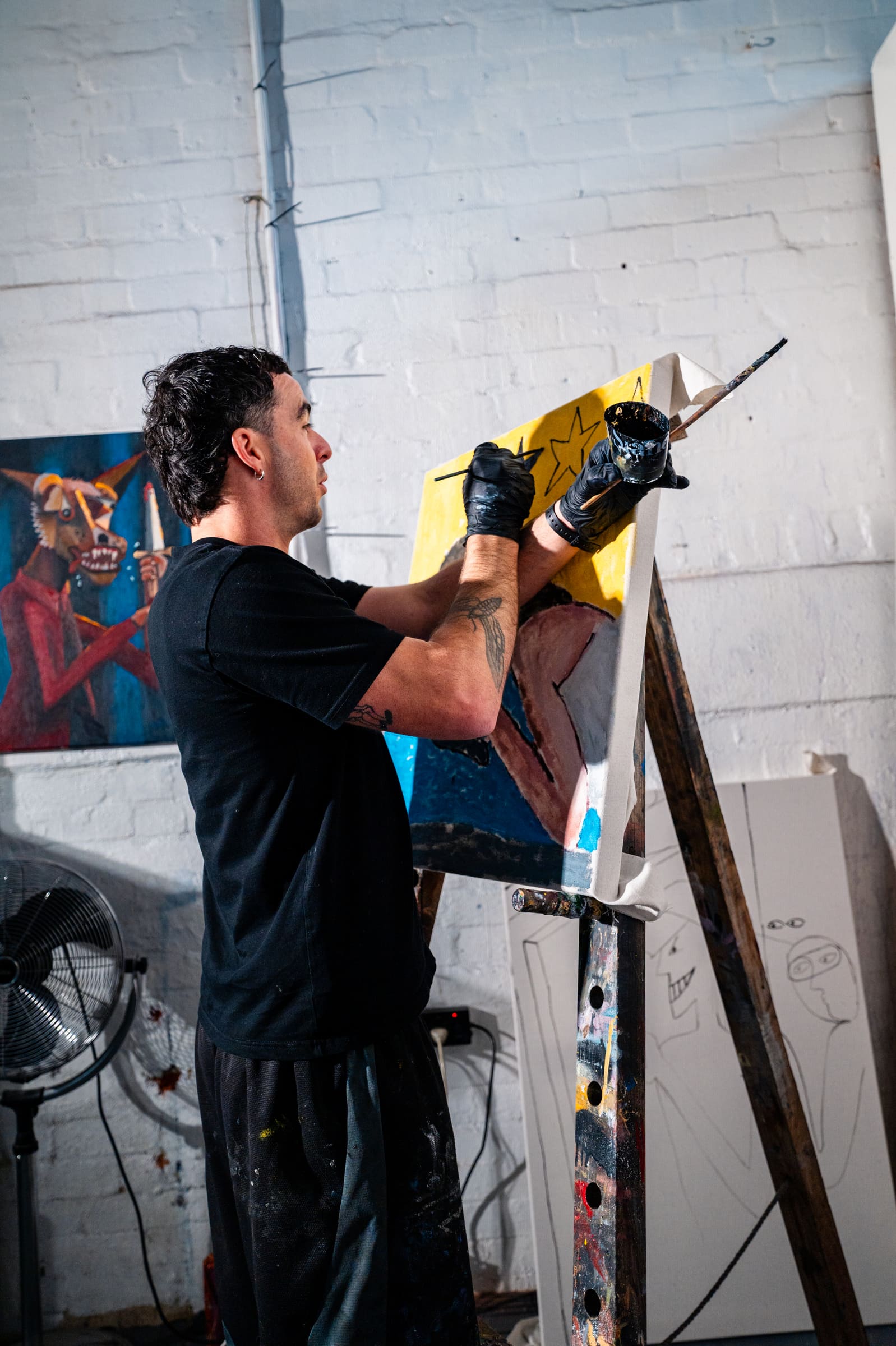 Chris working on a canvas at the easel