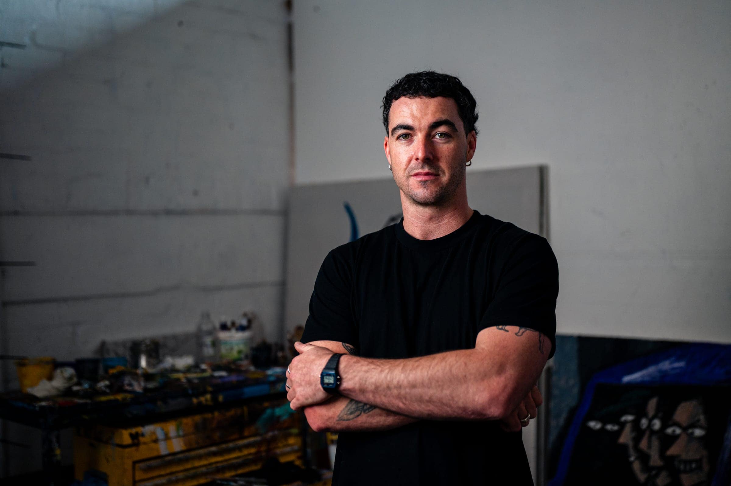 Chris in his studio, arms folded