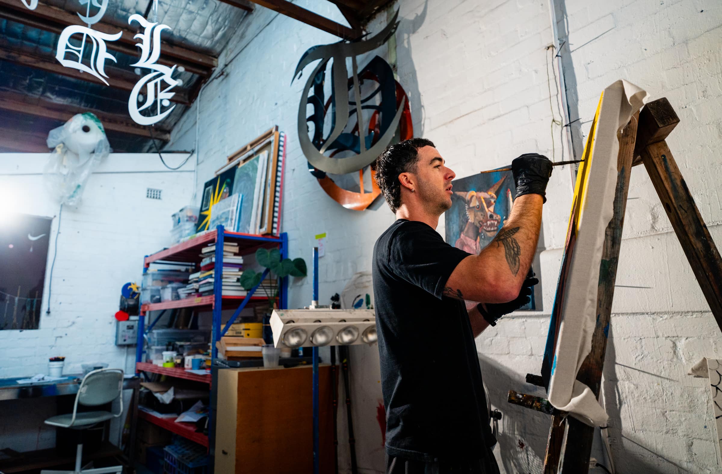 Chris painting at an easel in his studio